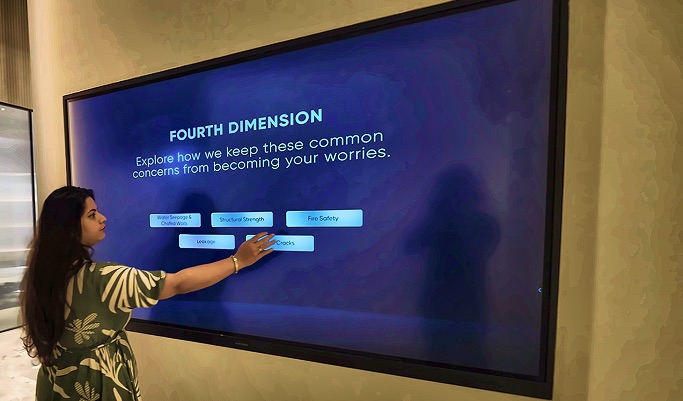 Visitor exploring construction quality features through an interactive Fourth Dimension touchscreen